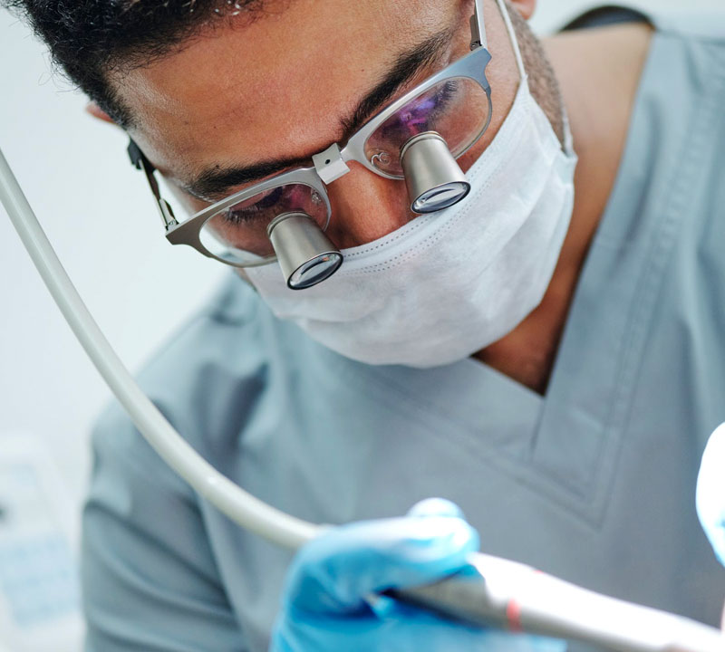 Dentist examining patient’s teeth in Houston dental clinic