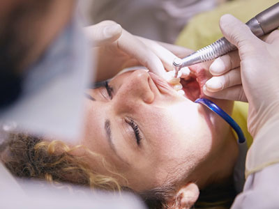 Dentist examining patient’s teeth in Houston dental clinic