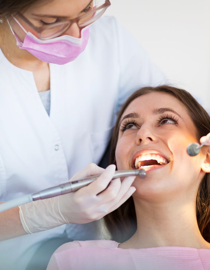 Dentist examining patient’s teeth in Houston dental clinic