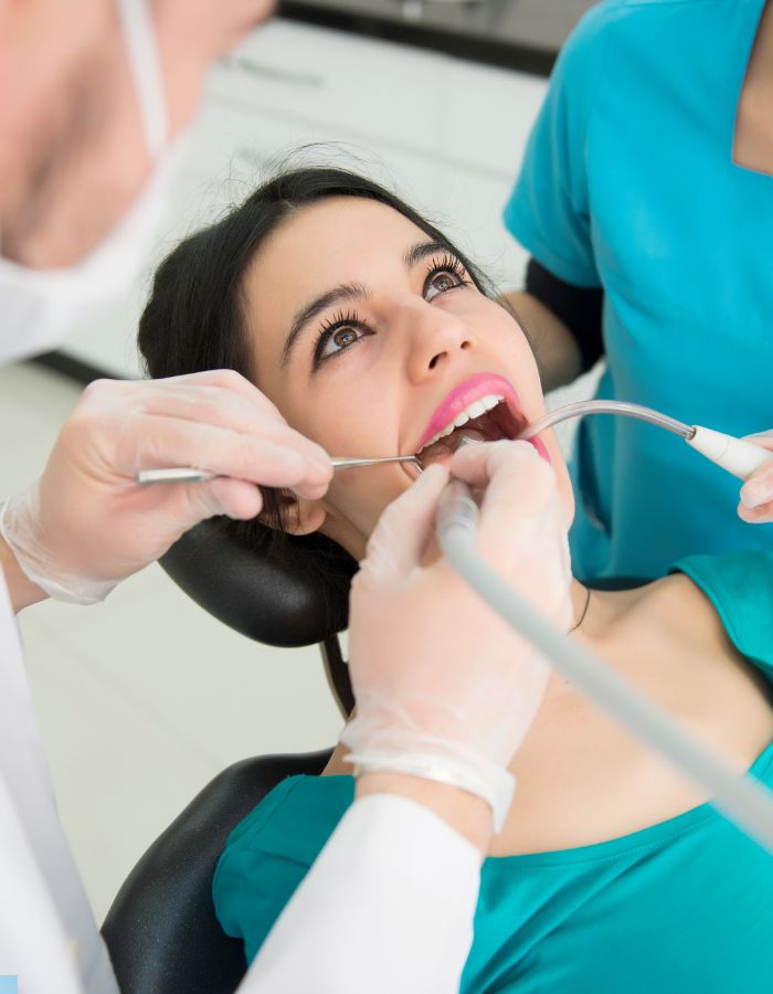 Dentist examining patient’s teeth in Houston dental clinic