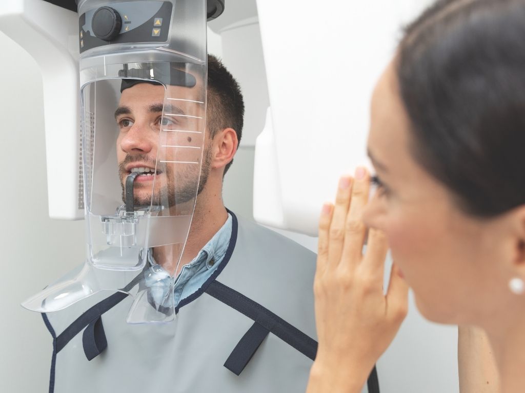 Female dentist performing a digital dental X-ray on a patient at Eker Dental Group in Izmir, Turkey.